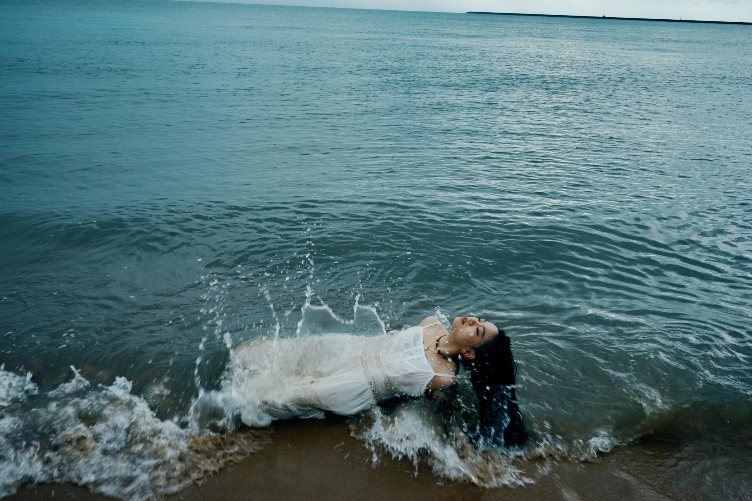 A wedding photographer writing a blog post on a laptop while Instagram is open in the background