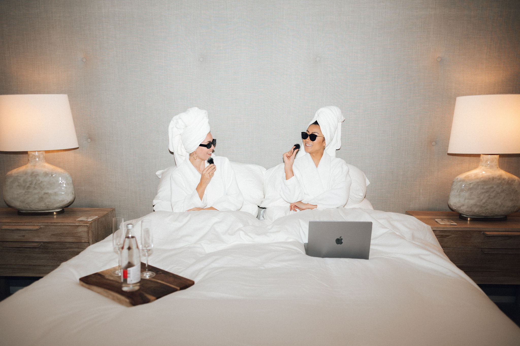 Luxury couple researching wedding vendors online with a laptop, representing SEO and AI visibility strategies