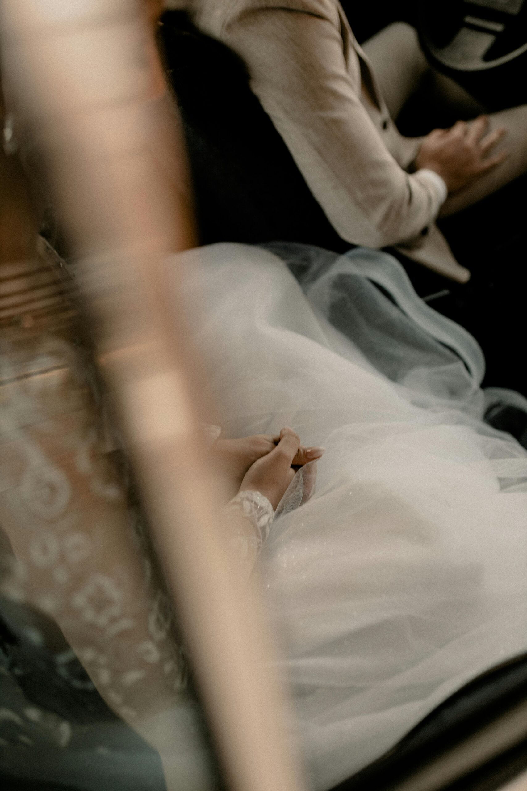 Two female creatives working side by side at a sunlit desk covered in notebooks, laptops, and coffee cups, symbolizing collaboration and creativity at North + South.